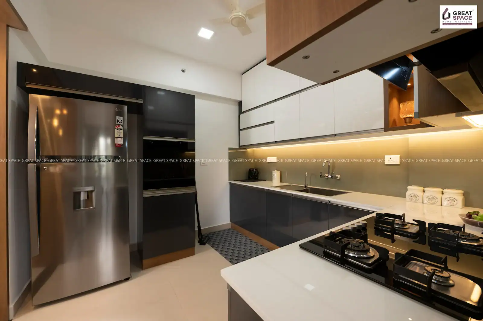 Modular kitchen with white, grey and wooden finishes in Vyttila apartment interior